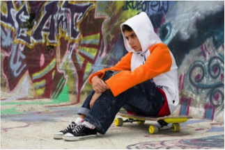 boy sitting on skateboard